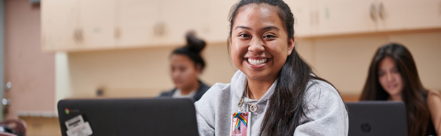 female student working on a laptop