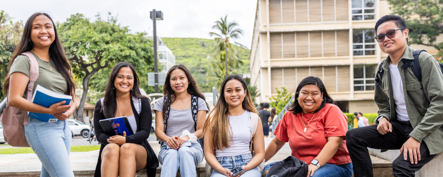 5 females and 1 male sitting on the stairway