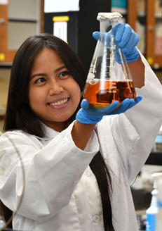 Girl in lab with beaker