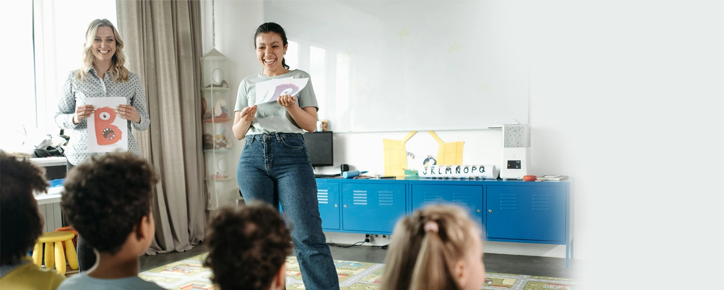 2 female teachers giving instructions to students